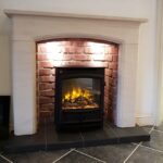 Sissari limestone fireplace with brick effect chamber
