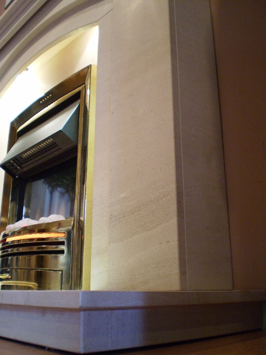 Dovetail Arch Limestone fireplace with lights